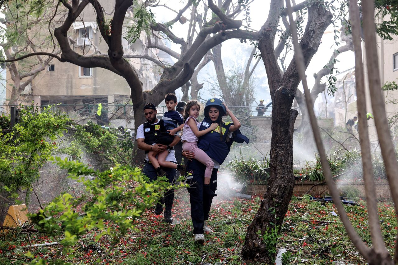 救援人员将儿童从特拉维夫导弹袭击现场撤离
